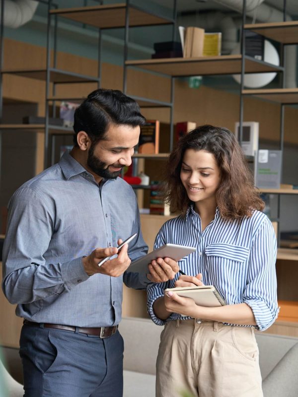 diverse-friendly-coworkers-talking-using-digital-tablet-in-office-1-1.jpg